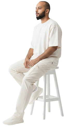 Syed Anees, sitting on a stool
